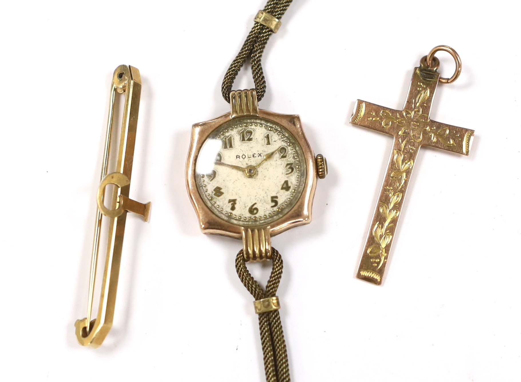 A lady's yellow metal manual wind wrist watch, the dial inscribed 'Rolex', a 9ct gold cross pendant and a 9ct bar brooch.